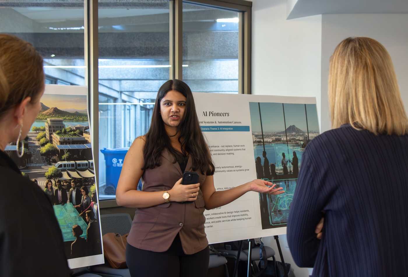 A student presents her project to faculty members, reflecting leadership within the Design (Visual Communication Design), MSD.