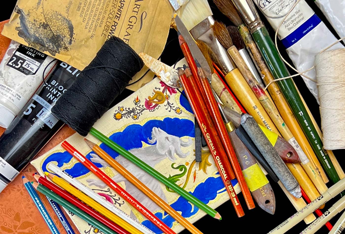 Art supplies, including paint, paint brushes and colored pencils, symbolize the field explored in the BA in Art (Art Studies).