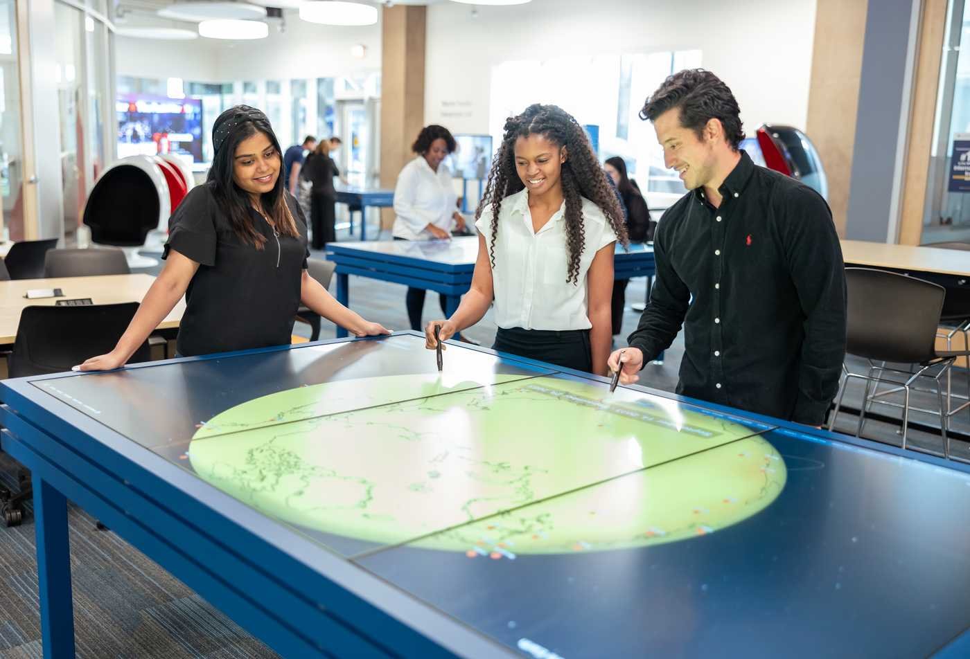 Students interact with a digital display created by a School of Art student, reflecting hands-on learning in the Art (Digital Technology), MFA.