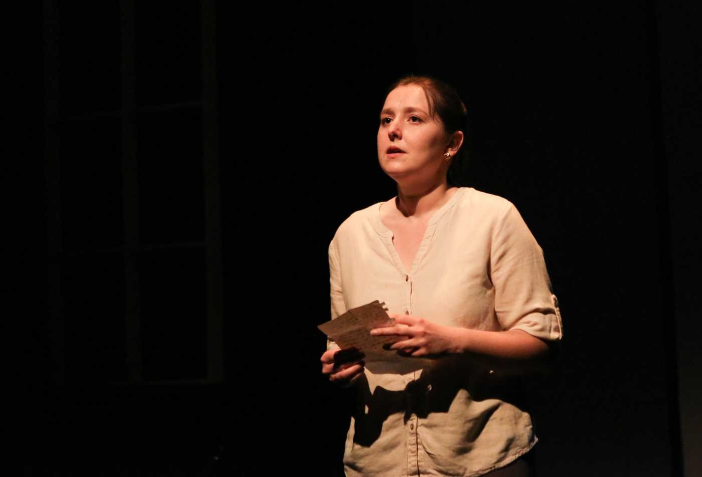 A performer delievers a monologue on stage, demonstrating hands-on learning in the Theatre (Dramatic Writing), MFA.