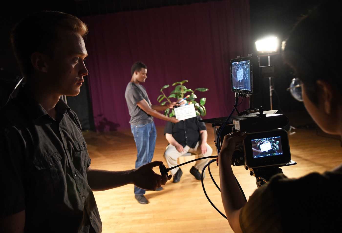 Students film a scene on a professional set, demonstrating the field explored in the BA in Film (Filmmaking Practices).
