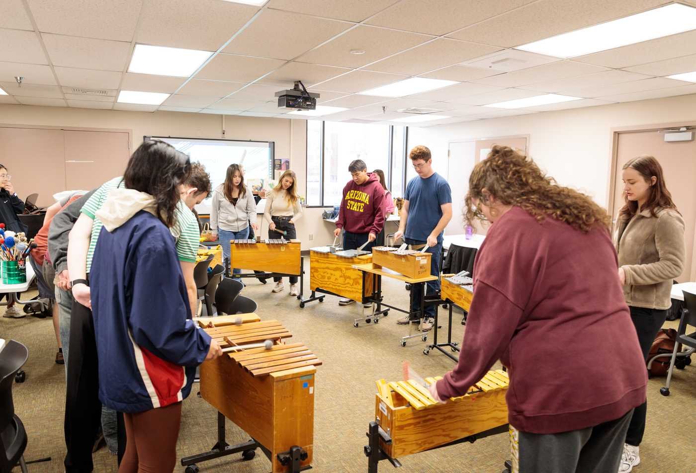 A classroom of students play xylophones together, demonstrating hands-on learning in the BMUS in Music Learning and Teaching.