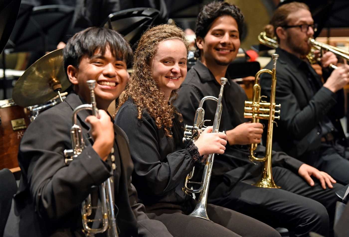 Trumpet students smiles at the camera, reflecting the field explored by the minor in Music.