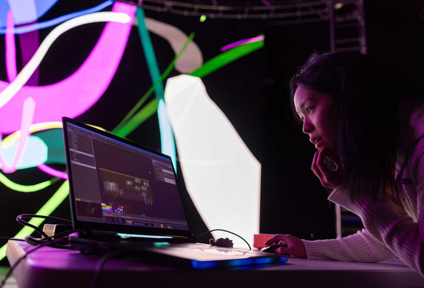 A student animates a swirl of colors, demonstrating the field of the minor in Animation.