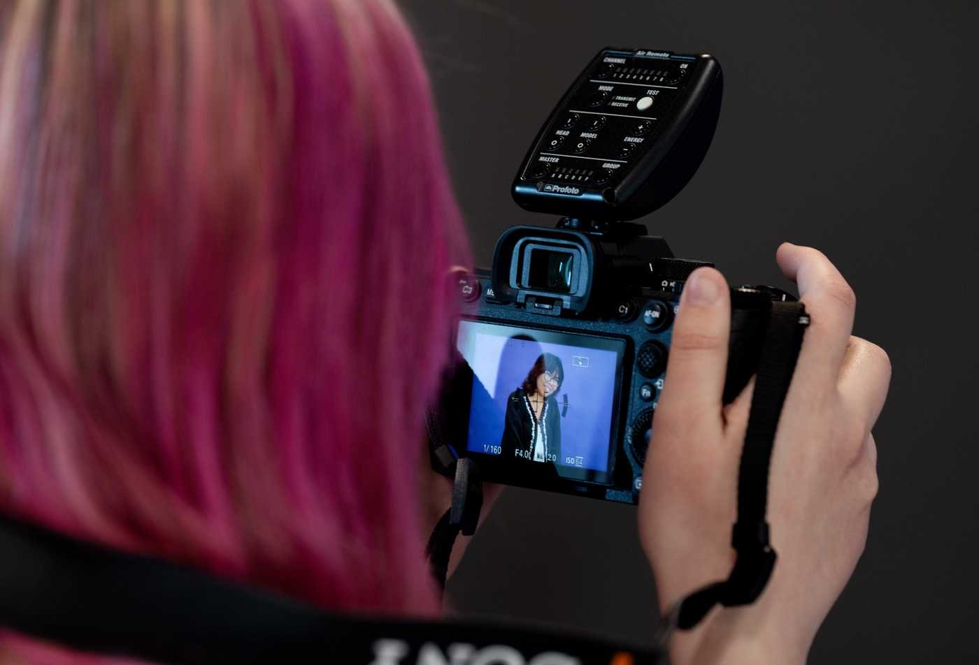 A student examines the photo she took with a digital camera, showcasing the field explored in the BFA in Art (Digital Photography).