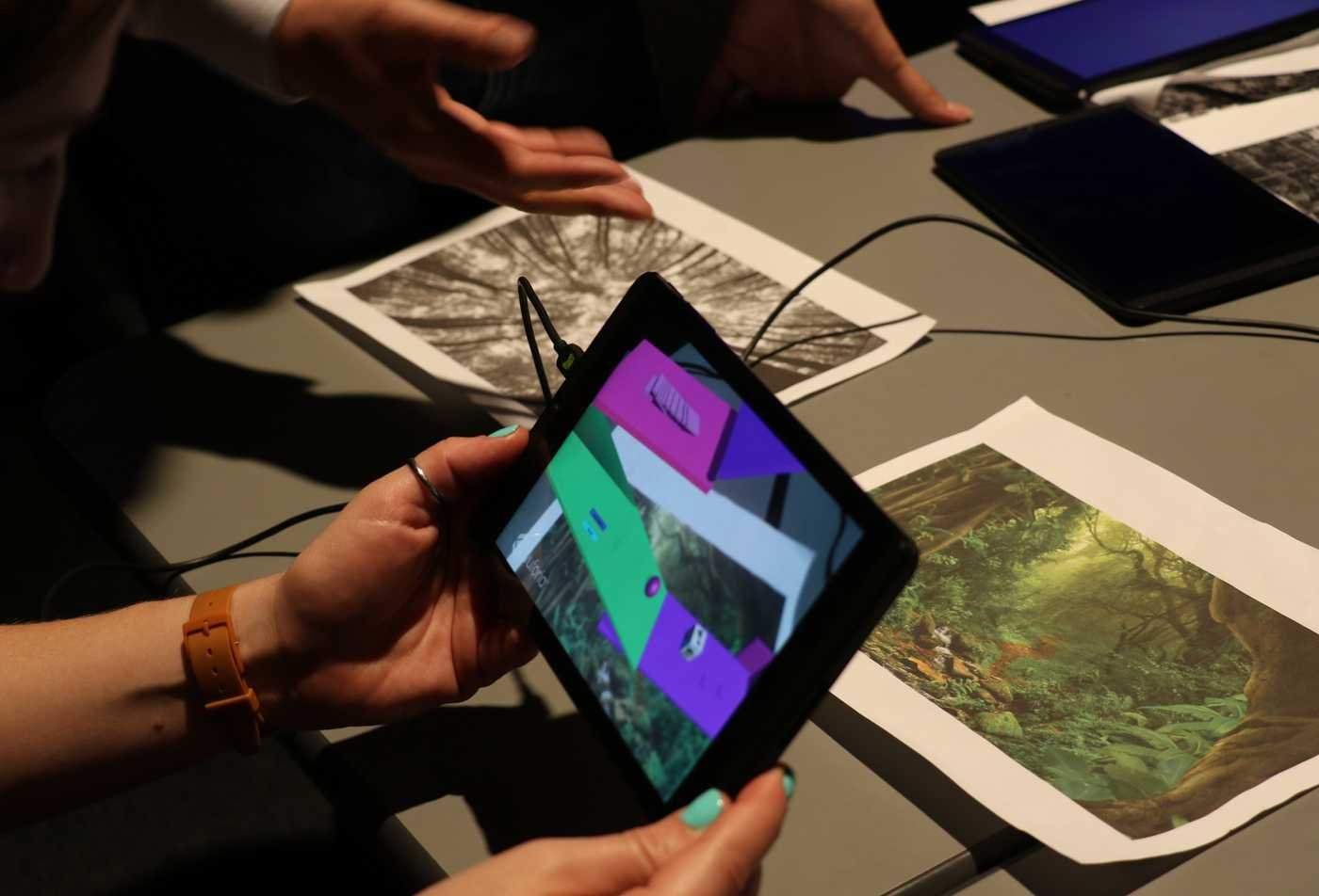 A student examines a 3D art project, showcasing hands-on learning in the certificate in Media Arts and Sciences.