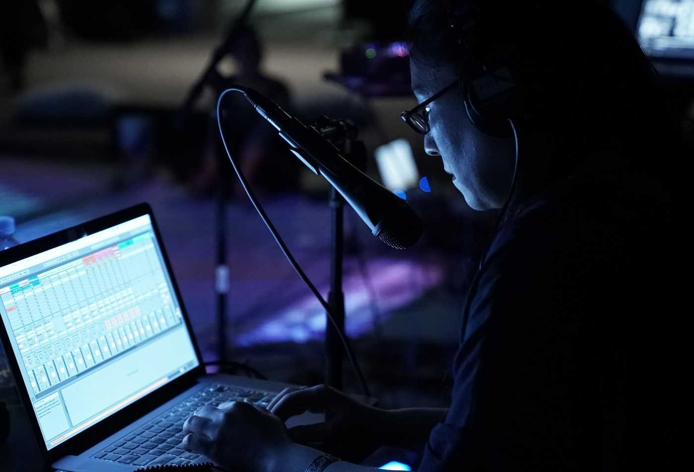 A student tinkers with sound settings on a laptop, demonstrating the field explored in the BA in Media Arts and Sciences (Music)