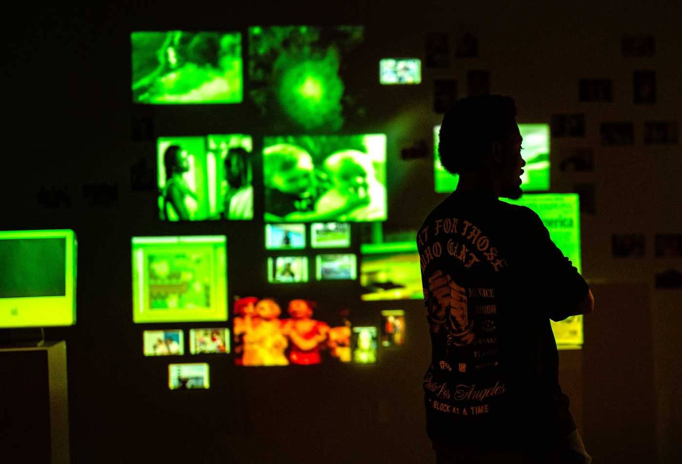 A silhouette of a man stands in front of multiple screens, showing the field of Media Arts and Sciences, MS.