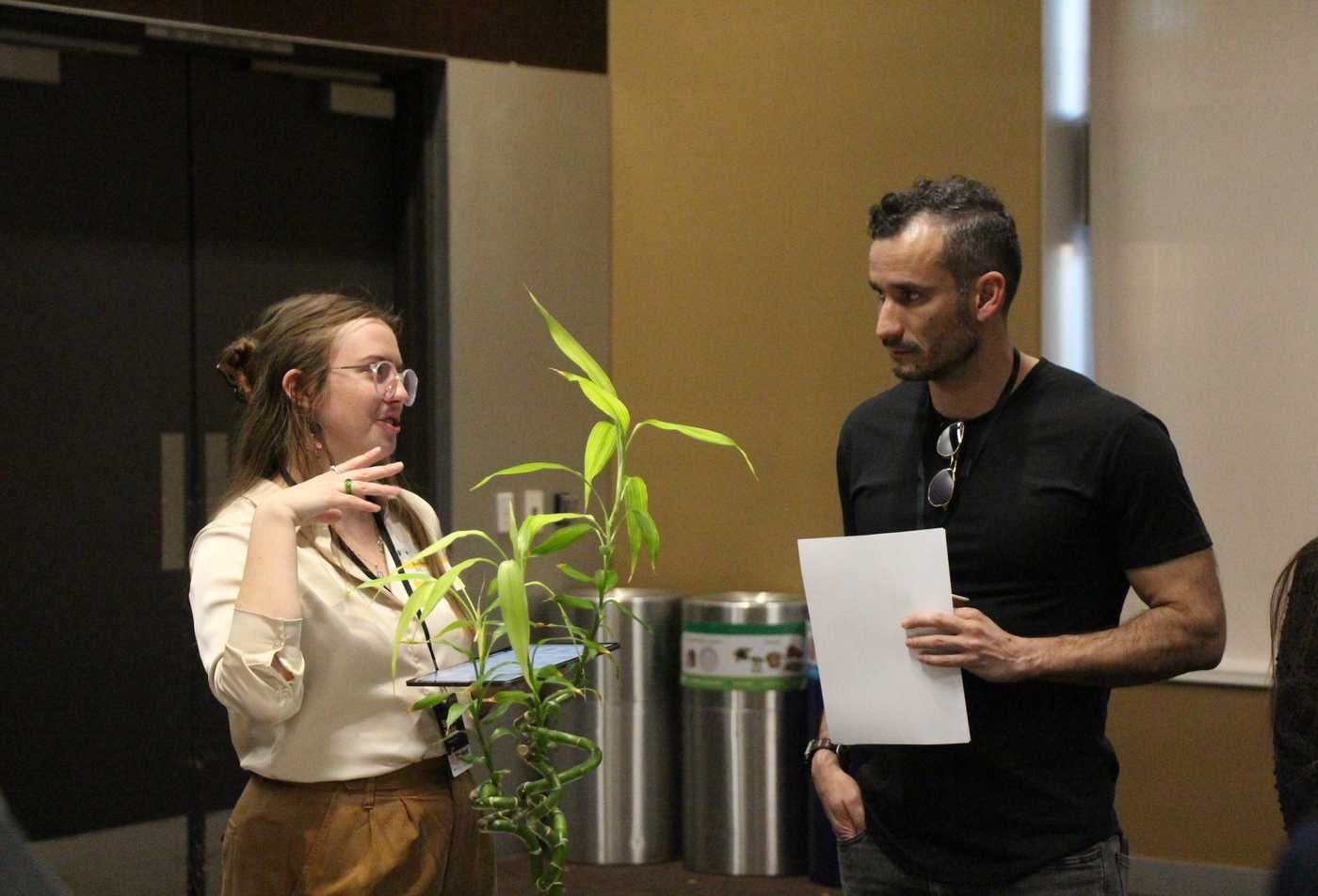 Two students discuss the impact of plants on an indoor environment in the BS in Environmental Design.