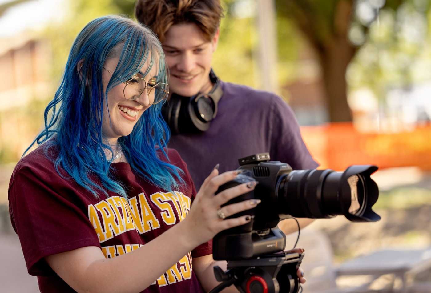 Students film a scene on a university campus, demonstrating the field explored in the BFA in Film and Media Production (Directing).