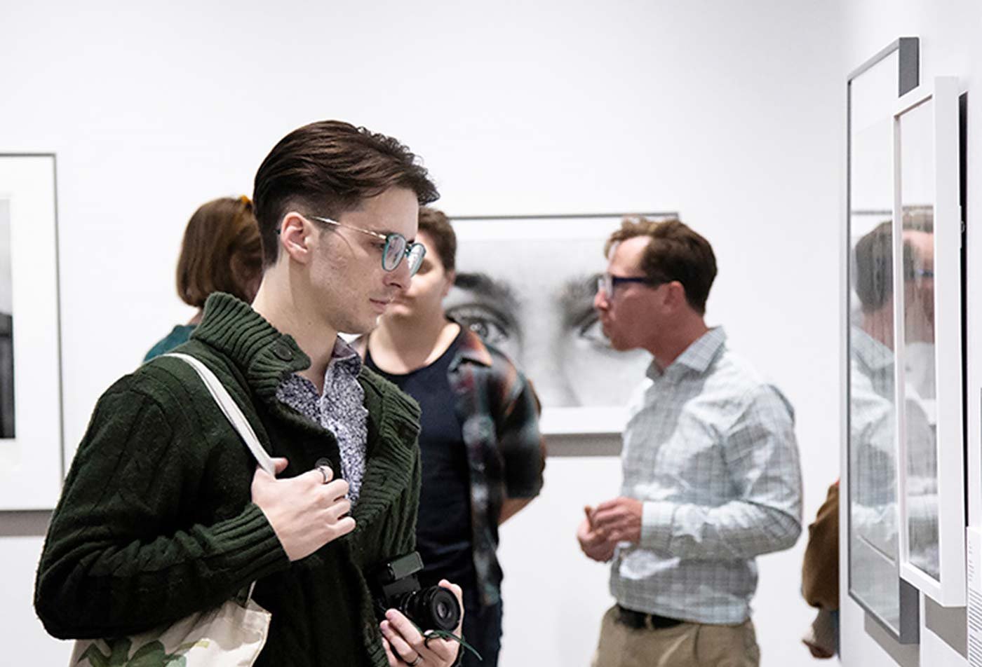 A photographer explores art museum exhibits, showcasing the field explored in the Museum and Curatorial Practices, MA