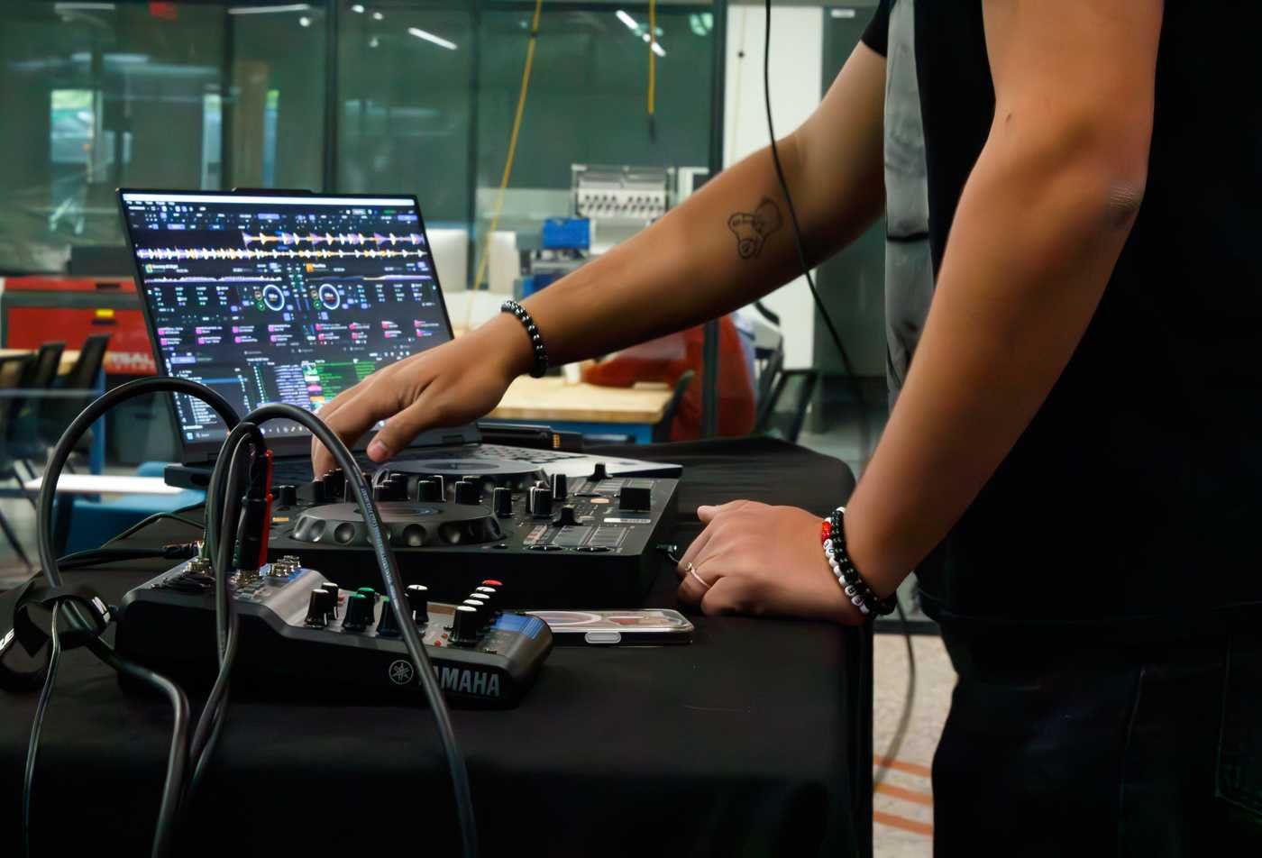 A student works on sound equipment, demonstrating hands-on learning in the certificate in Music Entrepreneurship.