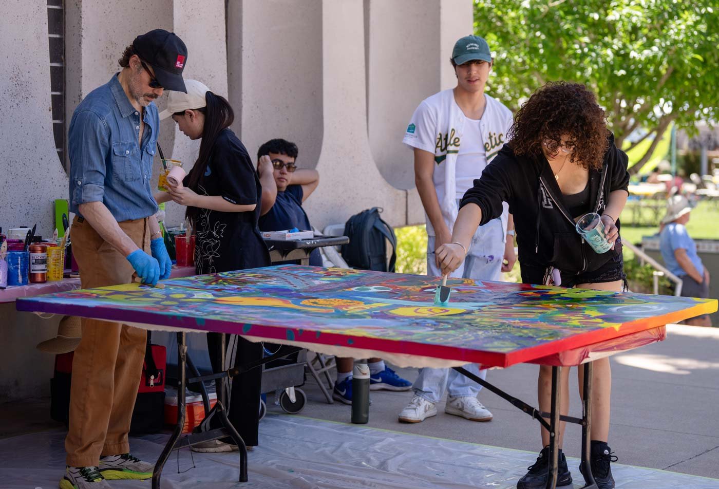 Students work on a community art project, reflecting community involvement in the certificate in Community-Engaged Practices in Design and the Arts