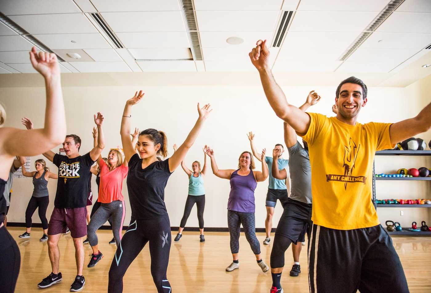 A workout class dances together, exemplifying the wellness commitement explored in the minor in Wellness Foundations.