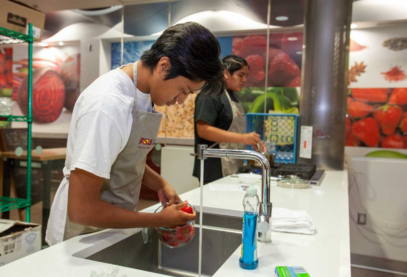 Students prepare ingredients in a kitchen, participating in hands-on study of the principles explored in the minor in Human Nutrition.