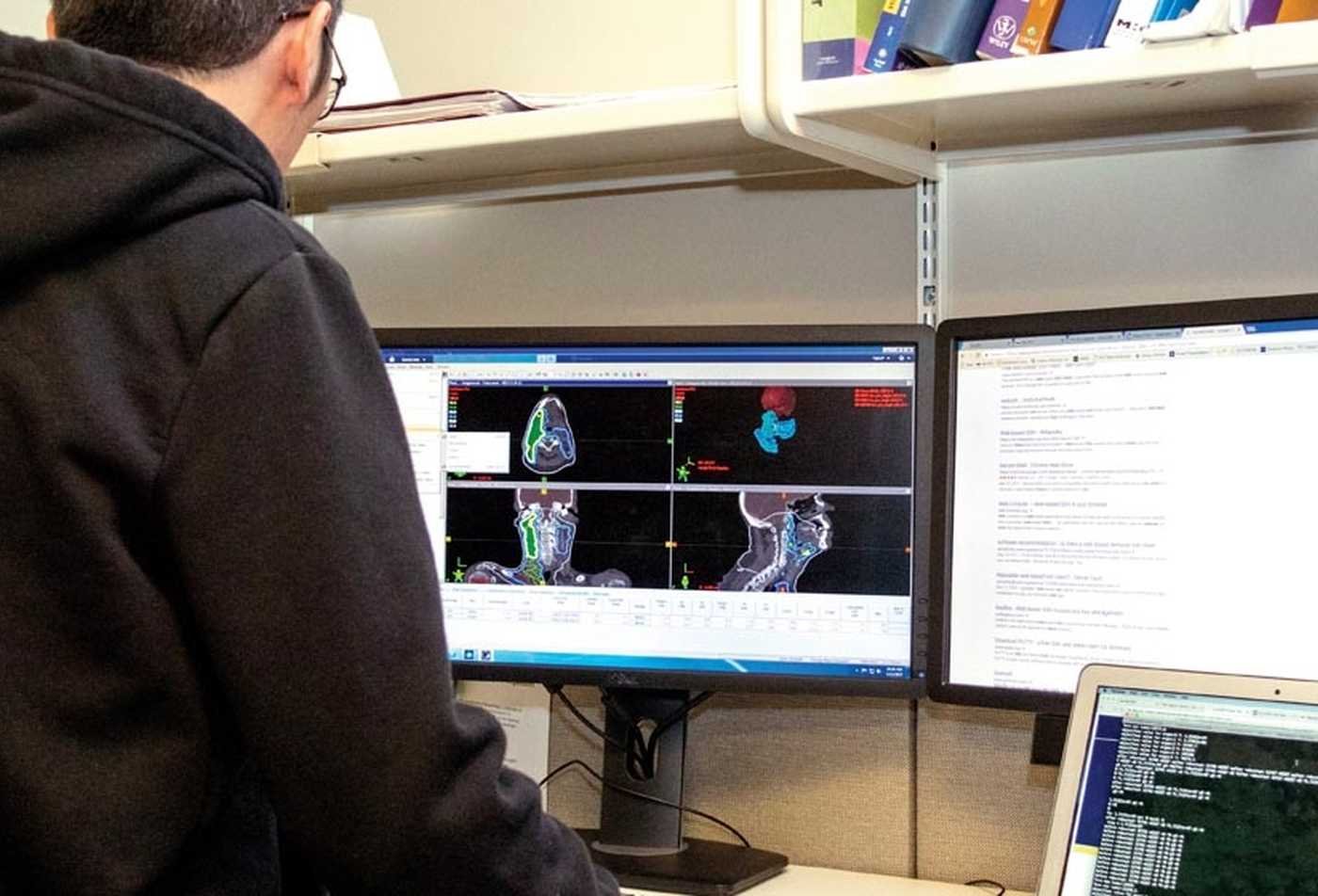 A student examines medical scans on a computer display, demonstrating hands-on learning in the PhD in Biomedical Informatics and Data Science