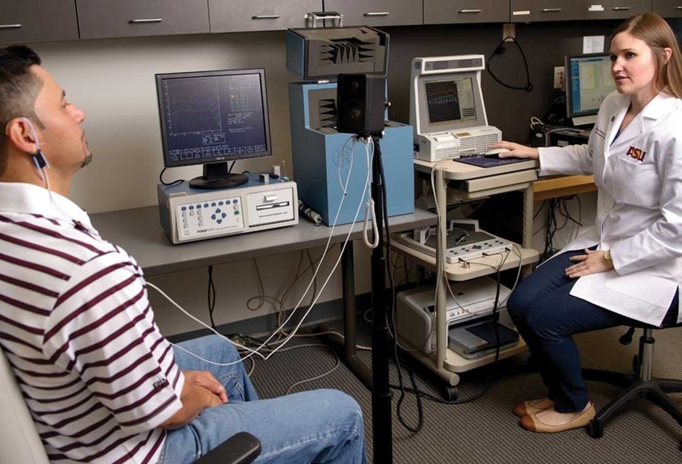 A researcher performs hands on research in hearing in the AuD in Audiology program.