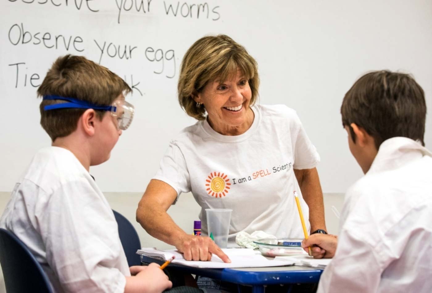An instructor engages with young students in a classroom, displaying the expertise learned in the MS in Communication Disorders