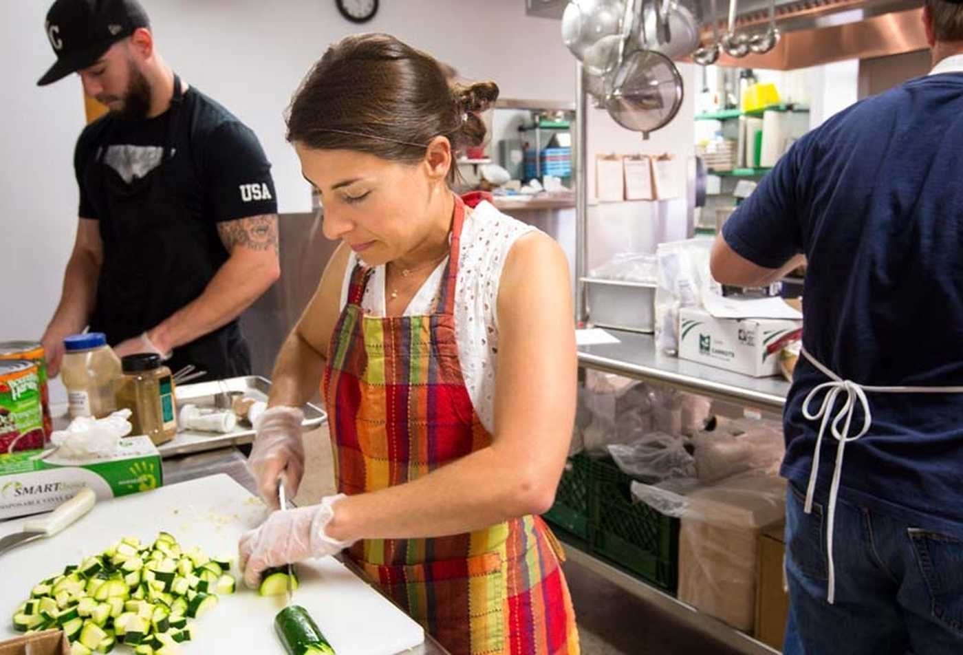 Students prepare vegitables in a commertial kitchen, participating in hands-on study of the principles explored in the BS in Applied Nutrition and Health