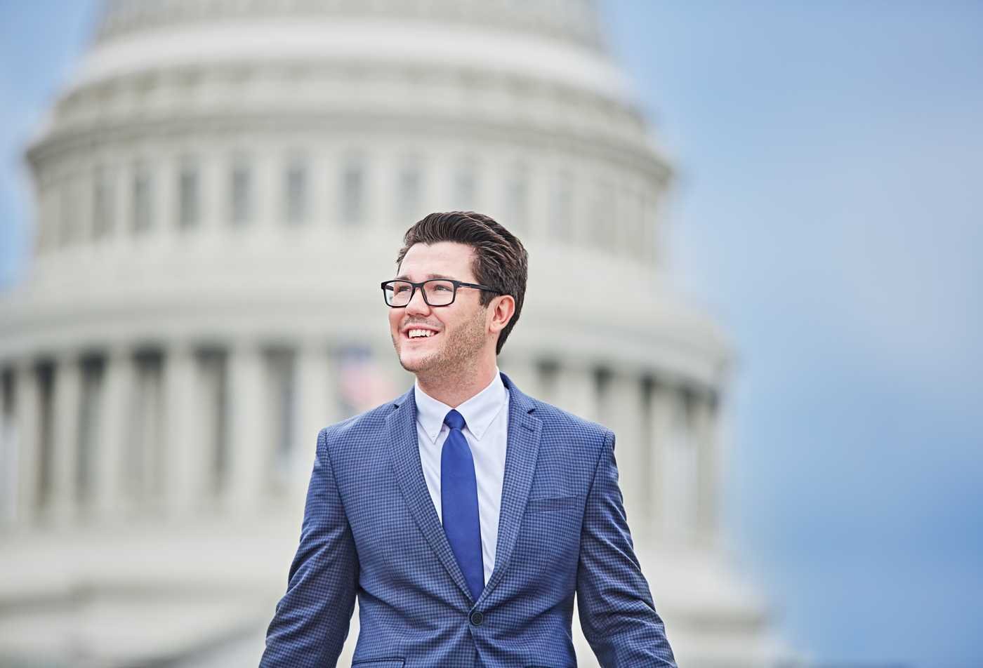 A policy professional works outside a capital building, demonstrating the field explored in the certificate in Health Care Policy and Delivery.
