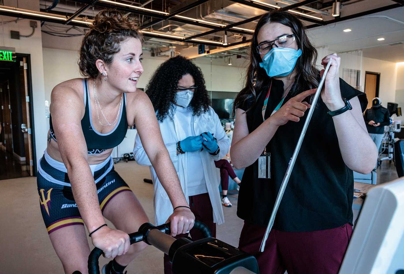 A student performs an experiment on an exercise bike, demonstrating the skills gained in the MS in Strength and Conditioning.