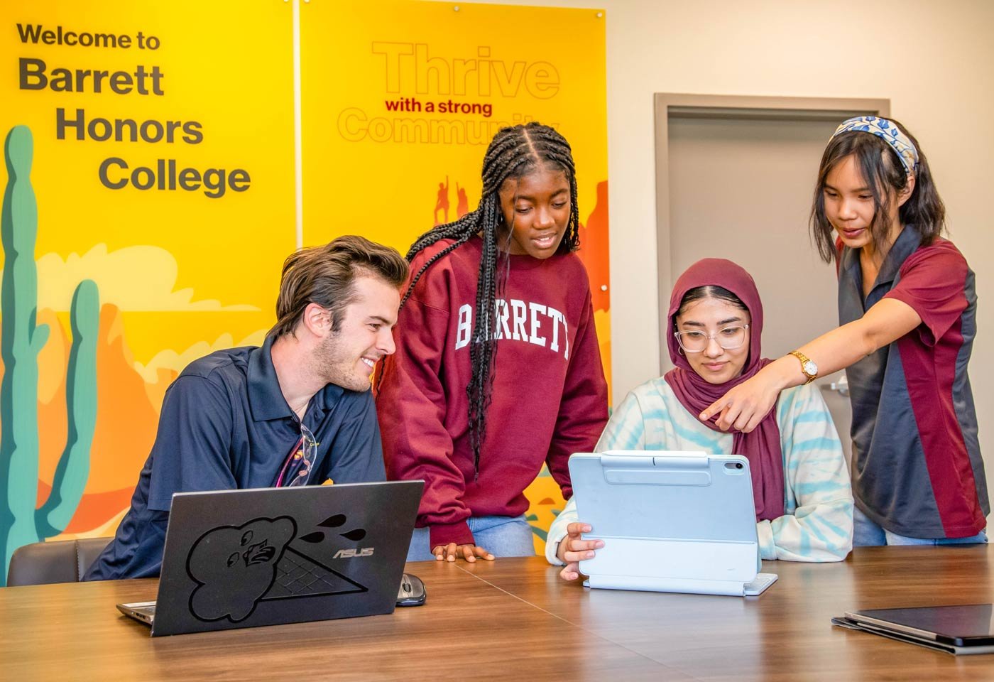 Barrett, The Honors College students collaborate on a project using laptops and a tablet, demonstrating student engagement in ASU's Honors College program.