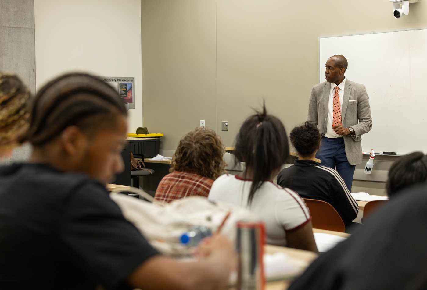 A professor lectures a African and African American Studies class, showcasing student experience in the minor.