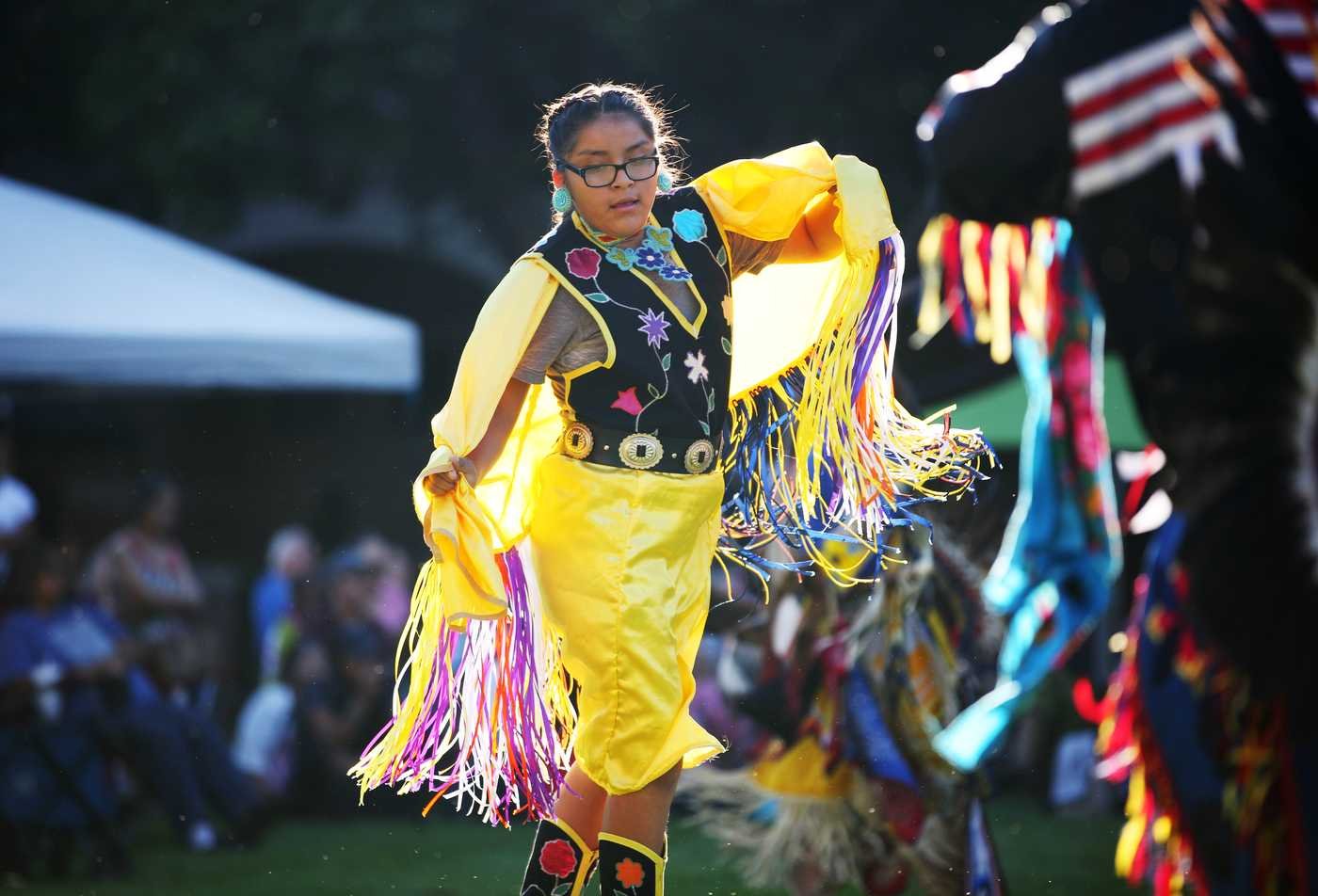 A Native American dances at a cultural event, showcasing the field explored in the minor in American Indian Studies.