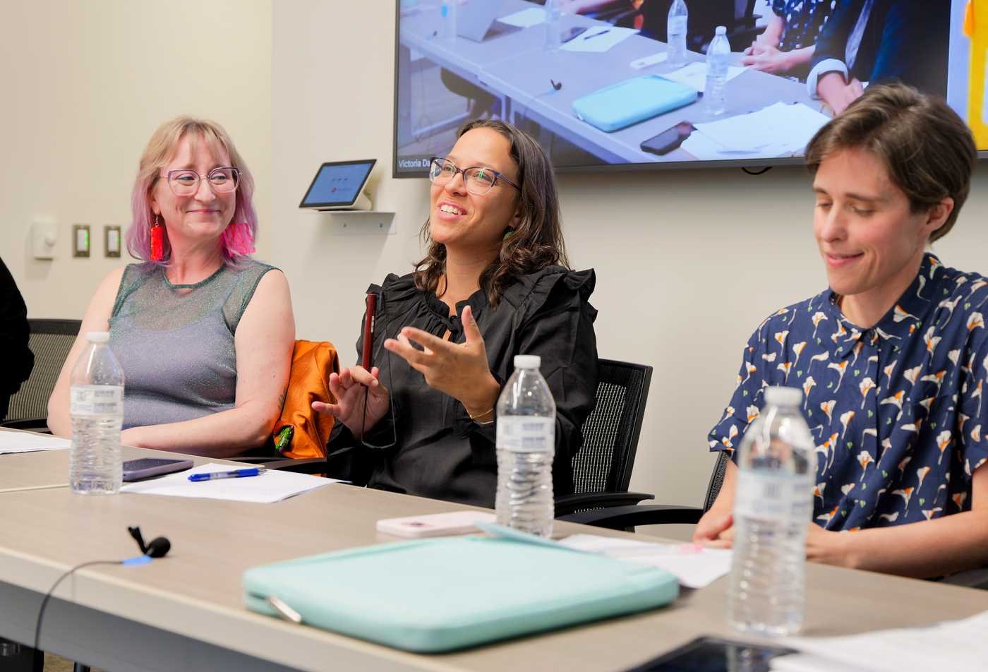 Film and media studies professor Aviva Dove-Viebahn sits between two guest speakers at a panel, demonstrating expertise in the MAS.