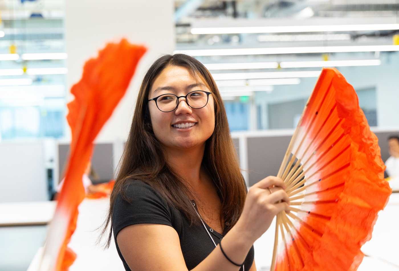 Students practice traditional fan movements, reflecting cultural learning in the certificate in Asian Pacific American Studies.