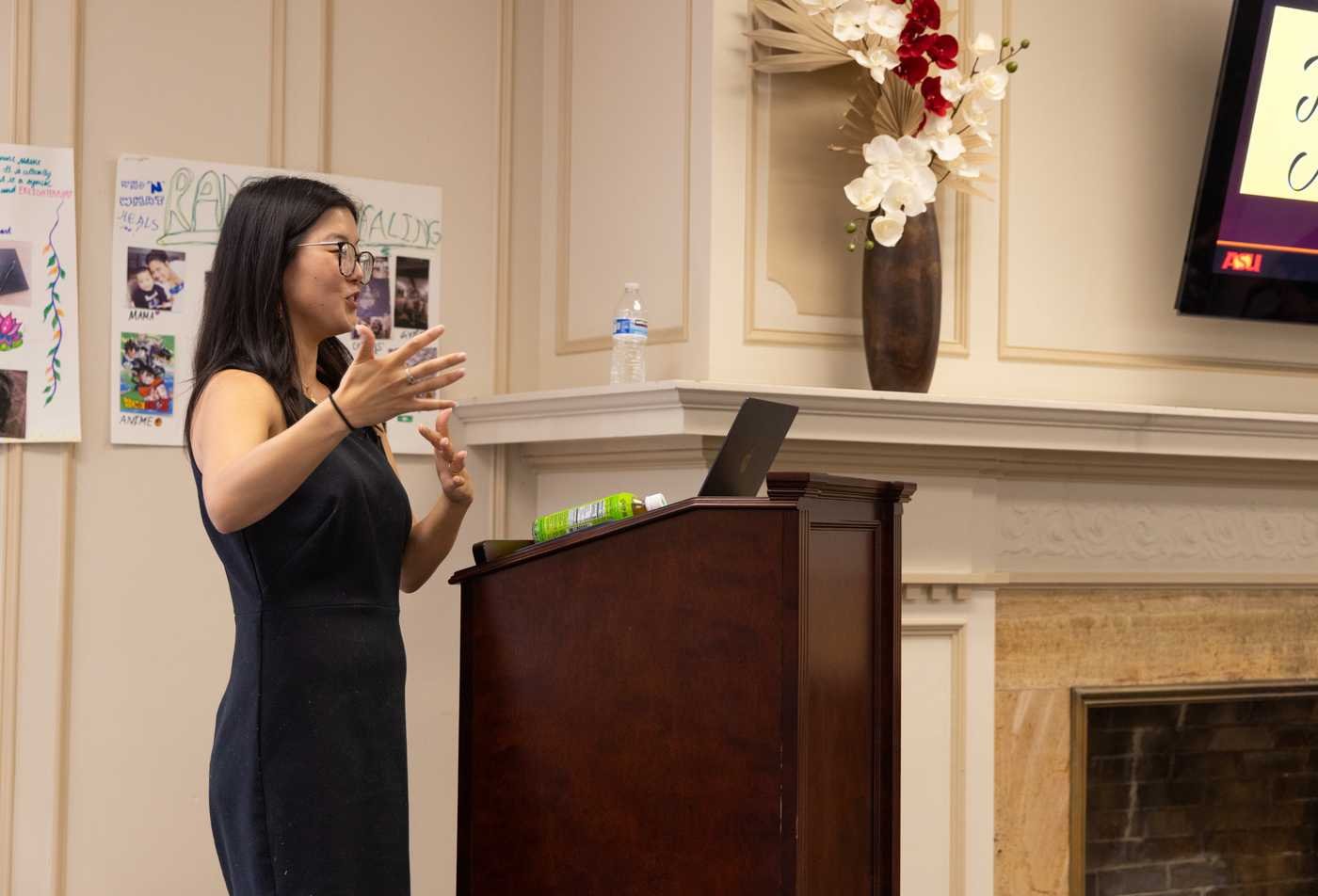 A instructor presents on Asian Pacific American Studies at a podium.