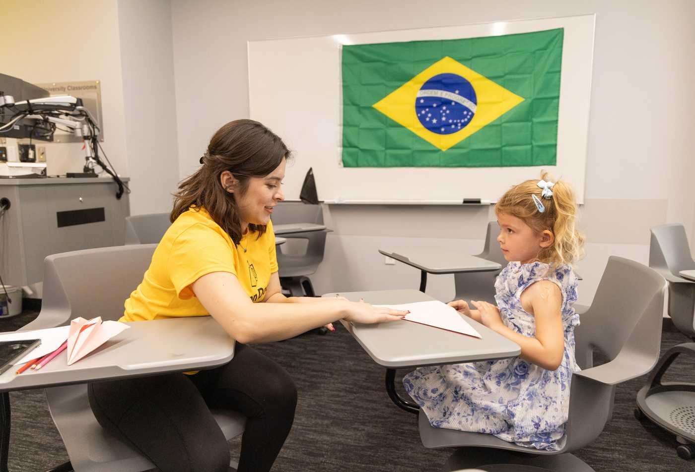 A Brazilian Studies student interacts with a young child, demonstrating the community impact of the certificate.