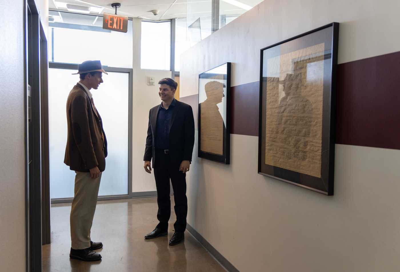 Two people discuss civic ideas beside historical displays, reflecting inquiry in ASU's Civic and Economic Thought and Leadership, BA program.