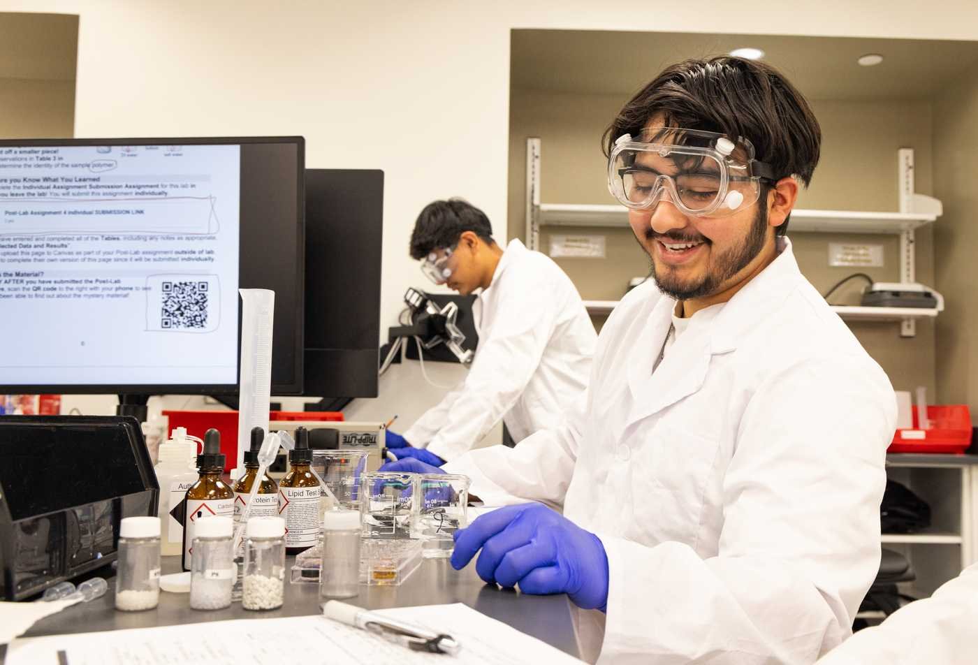 A student analyzes a chemical solution, exploring environmental processes in ASU's MS in Chemistry.