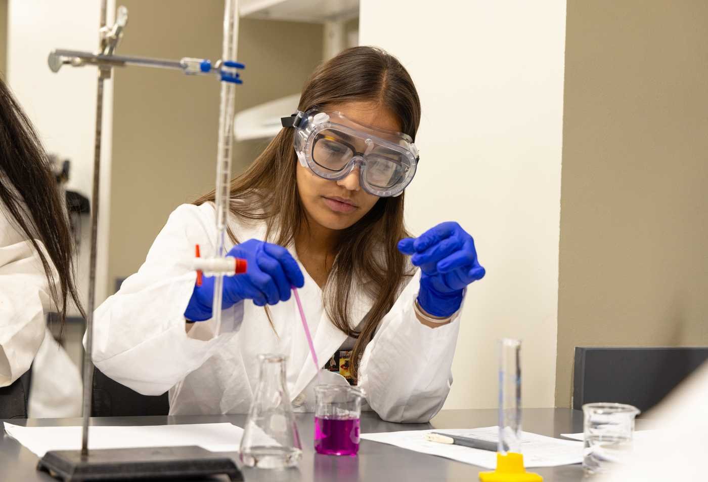 A researcher prepares samples in a laboratory, developing experimental skills in ASU's Chemistry, BA program.