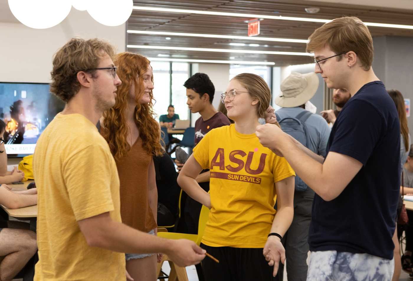 Four students engage in discuss on ASU campus, demonstrating a collaborative learning environment in the minor in Classical Civilizations.