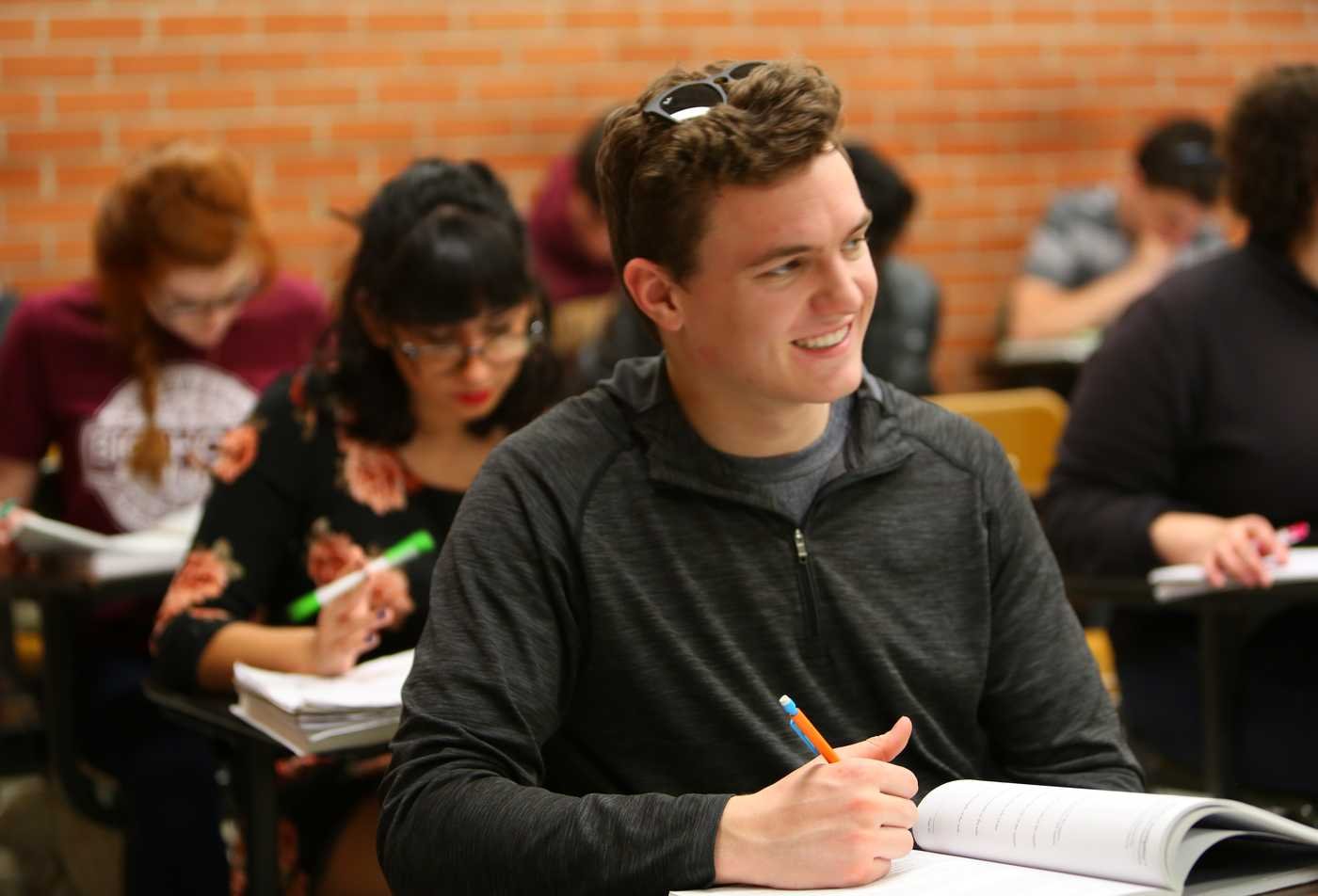 A student works through equations in class, applying quantitative reasoning in ASU's Computational Mathematical Sciences, BS program.