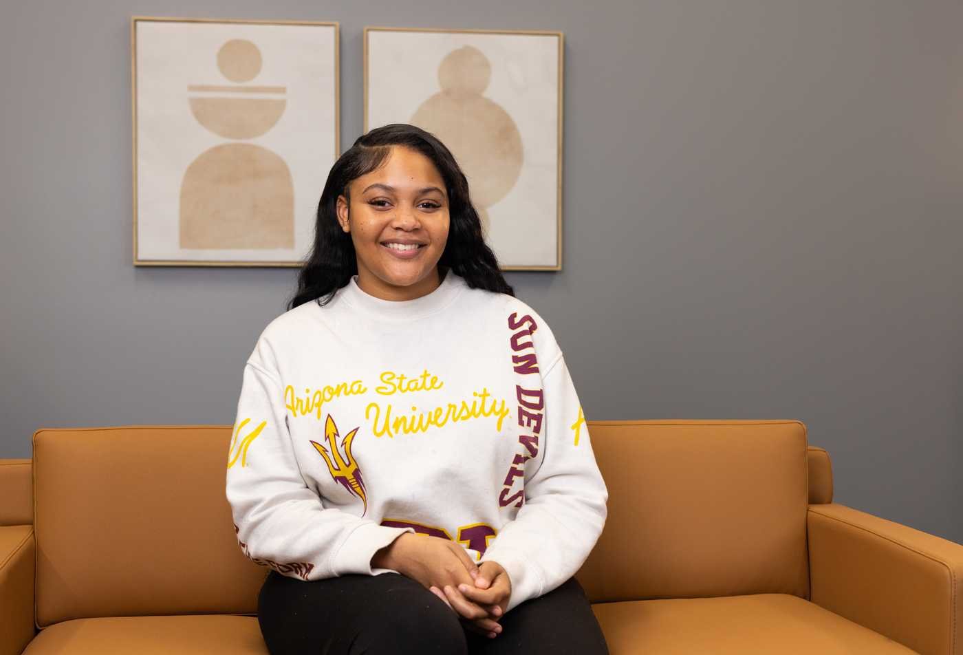 A student poses for the camera, symbolizing leadership in the Socio-Economic Justice (Graduate Certificate)