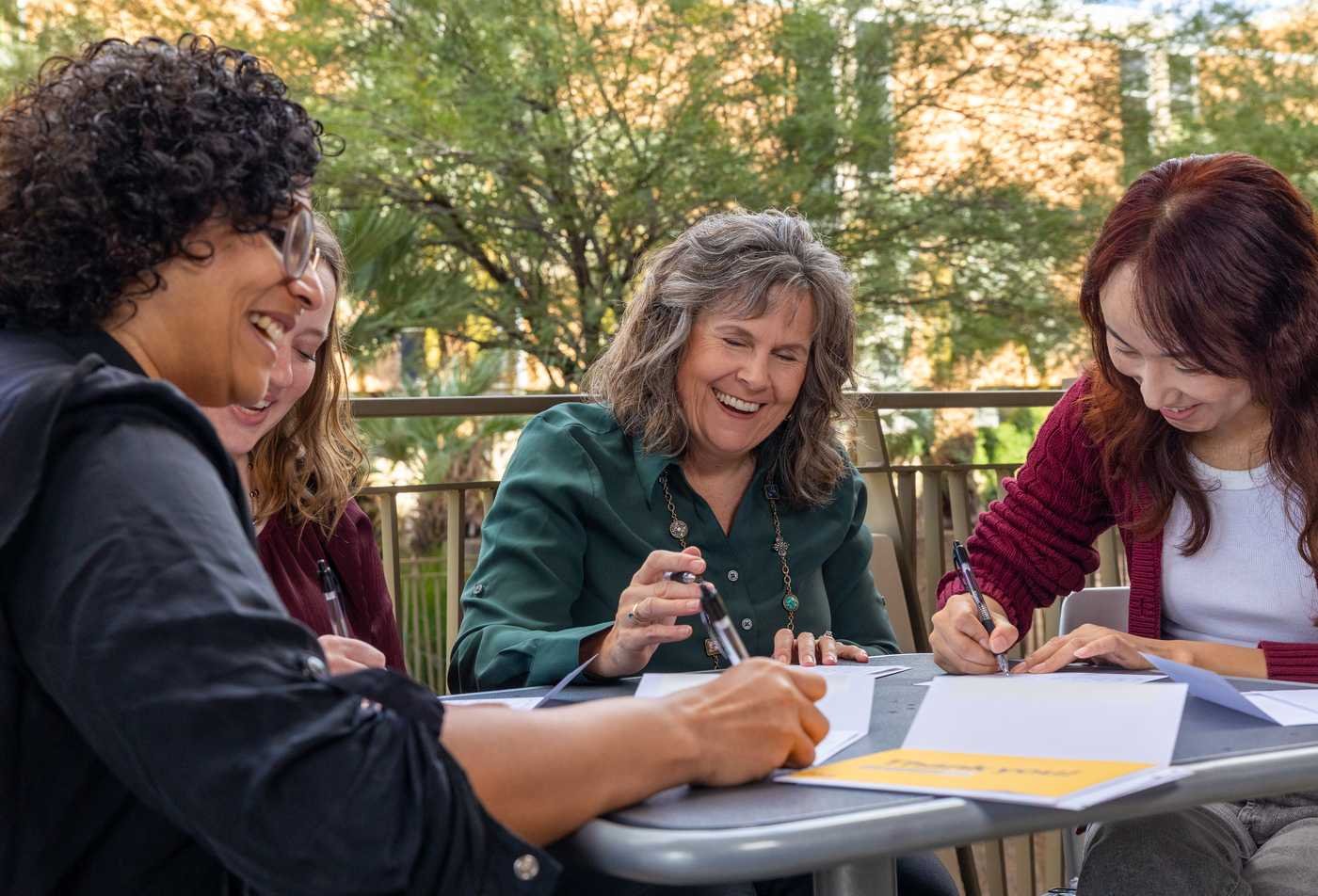 Faculty laugh together, demonstrating expertise in the Teaching English to Speakers of Other Languages, MTESOL.