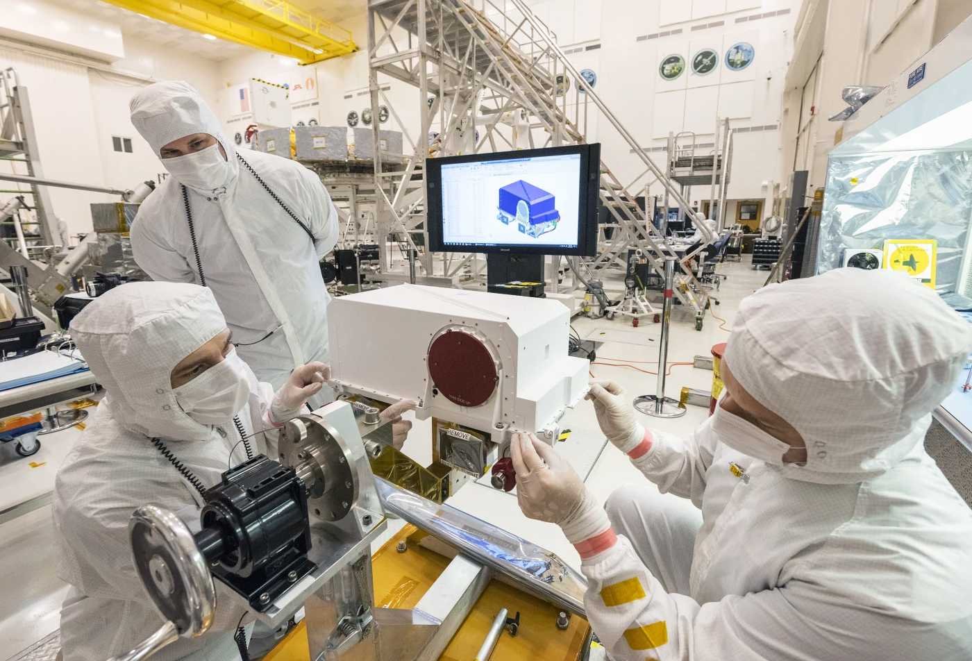Students and faculty in the School of Earth and Space Exploration work together using scientific instruments, showcasing the hands-on learning in the Exploration Systems Design, MS.