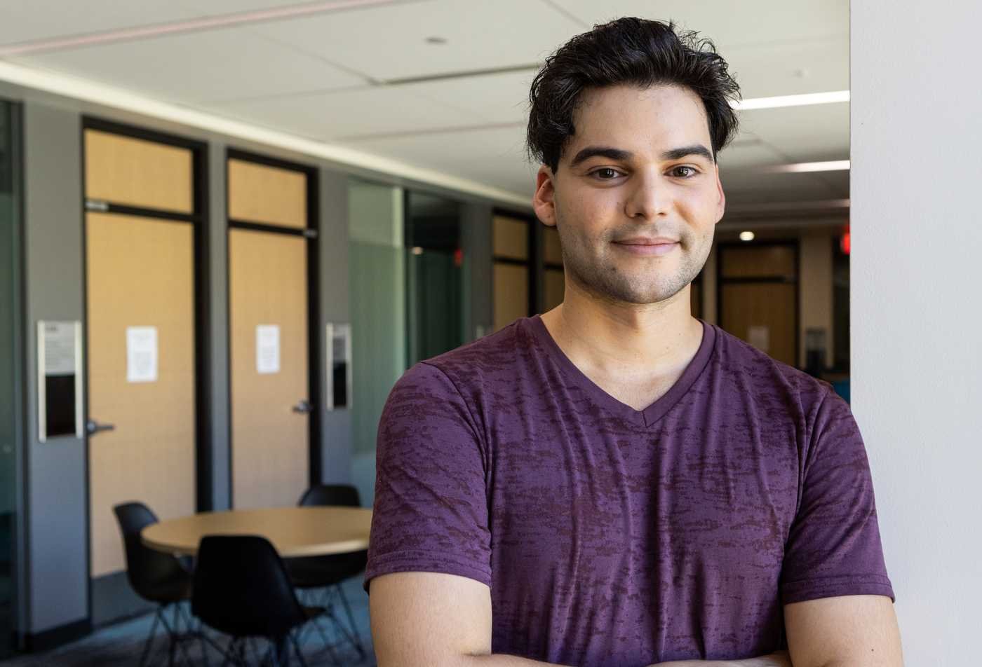 Student stands inside Durham Hall on ASU campus, symbolizing the expertise gained in the French Comparative Literature, MA.