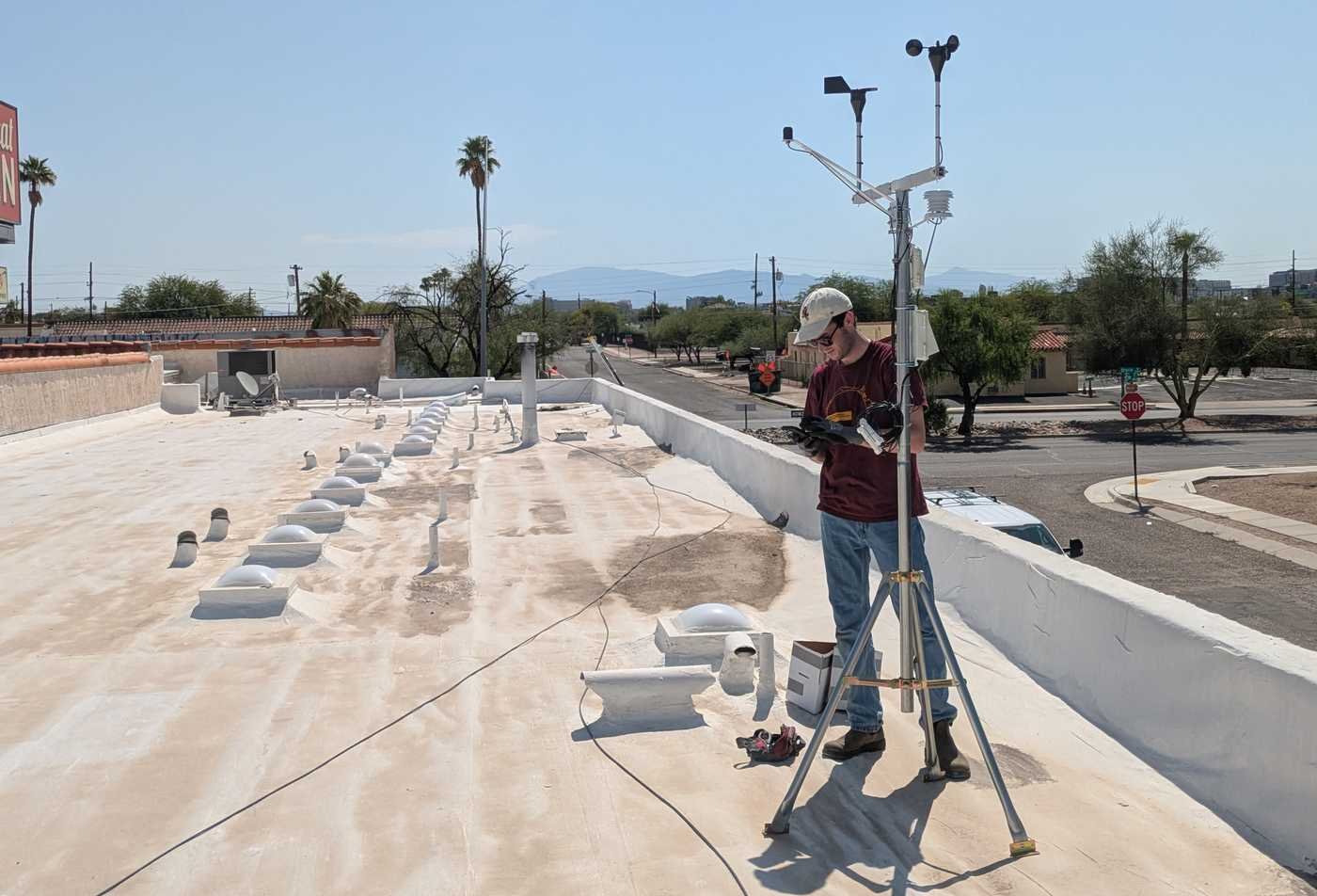 A researcher collects rooftop field data, exploring environments in ASU's Geography, BA program.