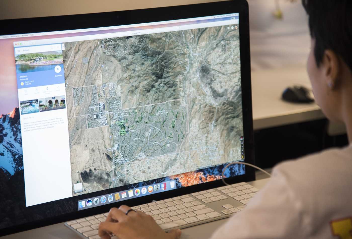 A student analyzes a digital map, applying spatial research in ASU's Geography, BS program.