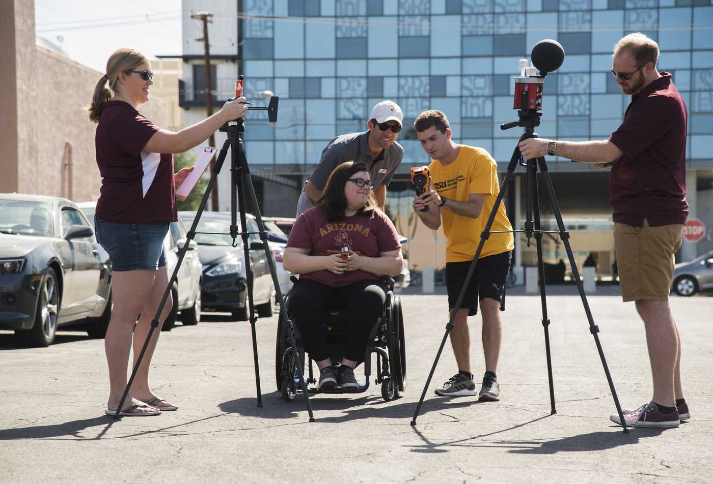 A field team operates weather instruments outdoors, studying climate in ASU's Geography (Meteorology-Climatology), BS program.