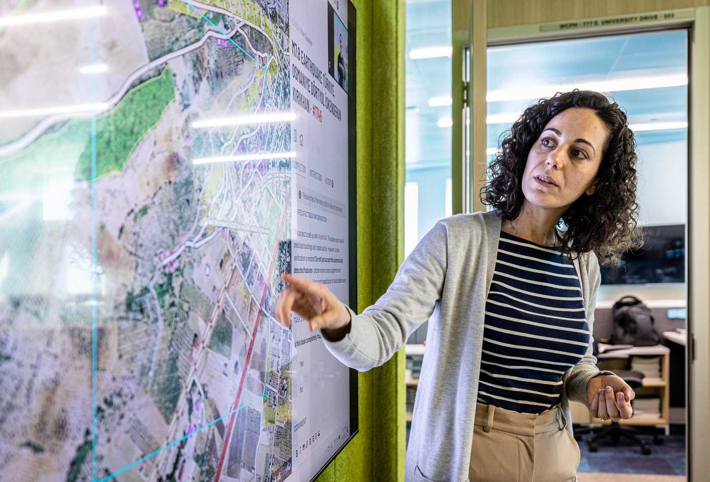 A researcher analyzes a digital map, applying spatial data in ASU's Geographic Information Science, BS program.