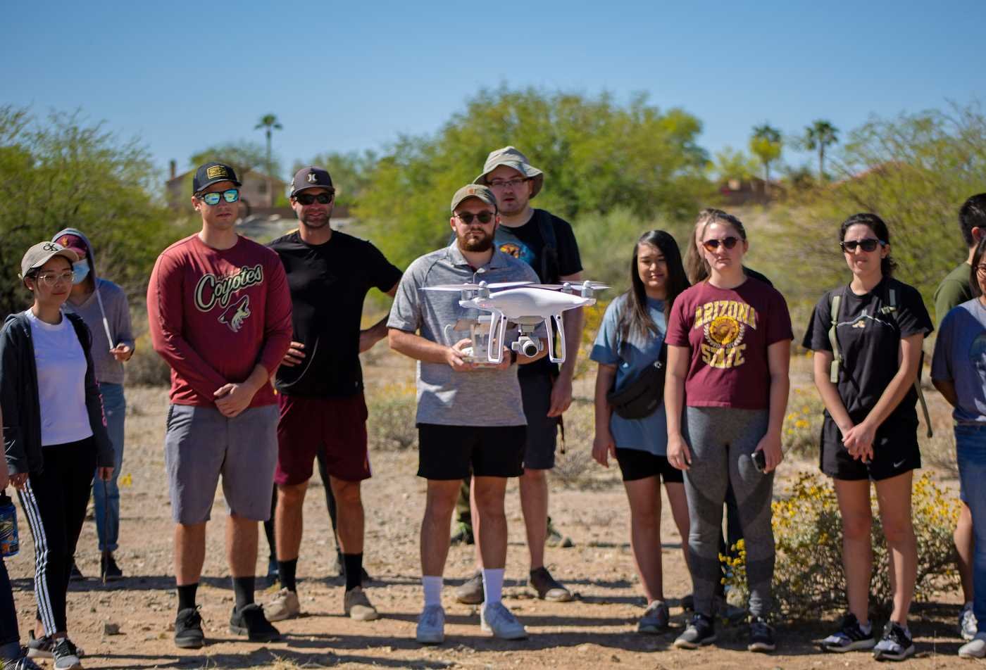 Students conduct a drone demonstration during an outdoor field class, demonstrating hands-on learning in the Geographic Information Science, MAS.