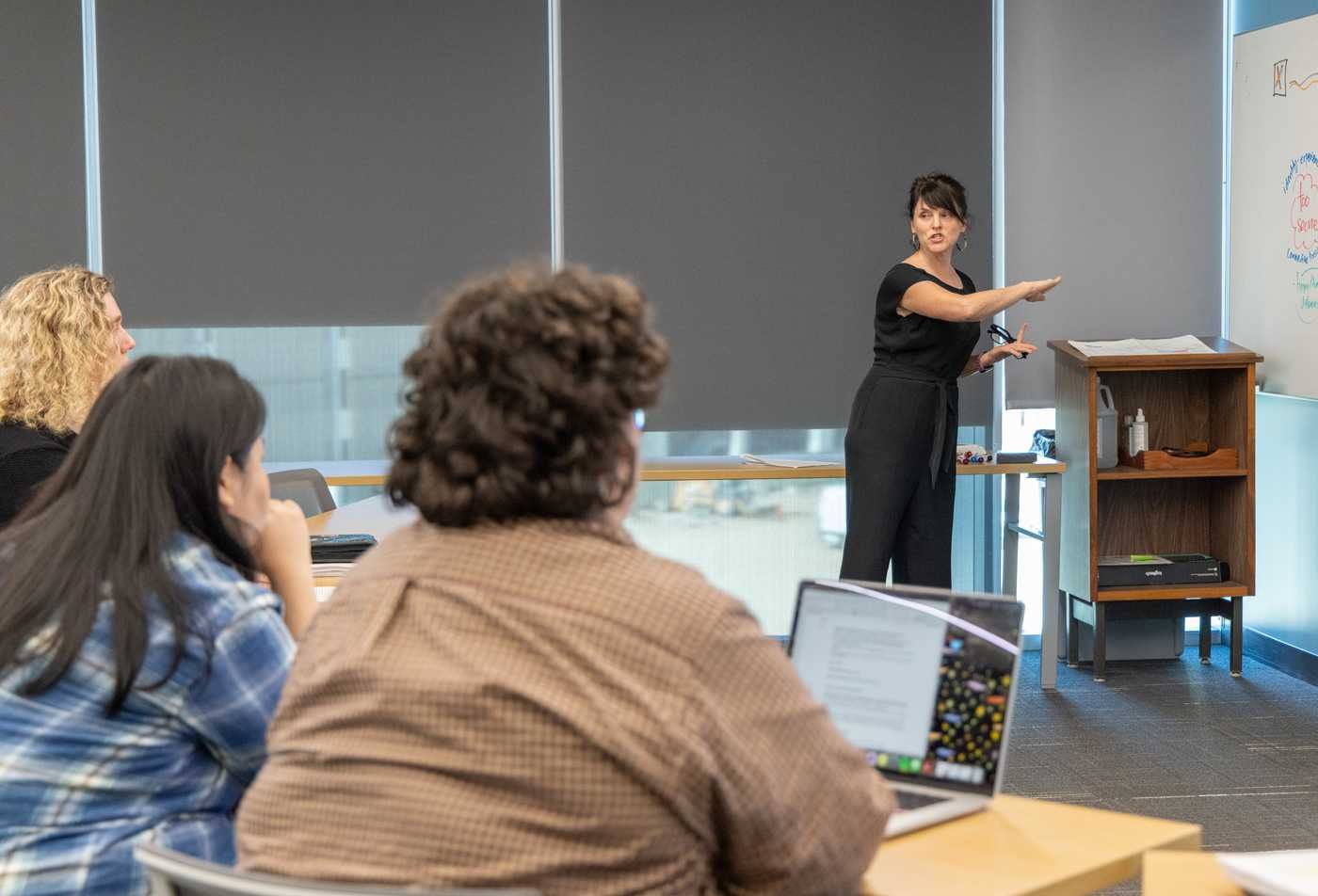 Professor Heather Switzer teaching a gender studies course to a group of students, demonstrating mastery in Gender Studies, PhD