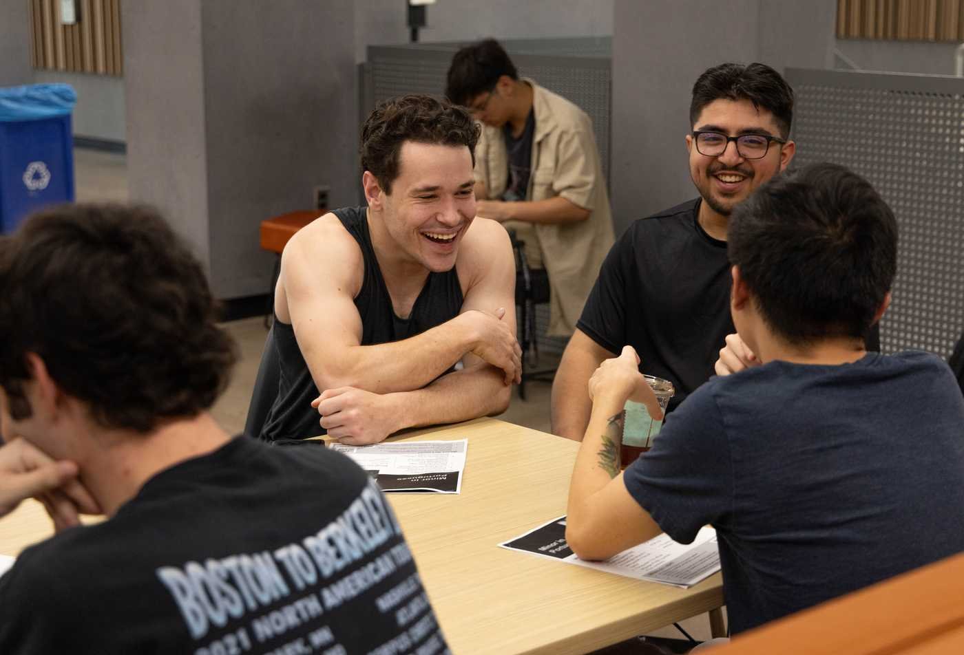 Students sit around a table laughing, demonstrating community in the certificate in Modern Hebrew.