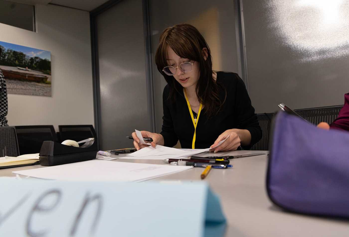 A student examines study materials, developing mastery in the History, PhD.