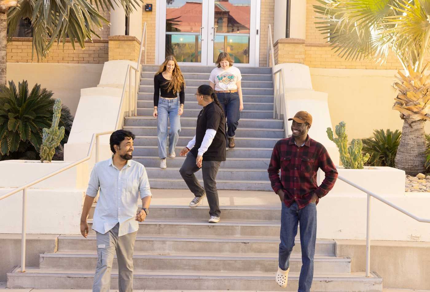 Students in the School of Human Evolution and Social Change laugh outside on Tempe campus, showcasing the community in the Immigration Studies (Graduate Certificate).